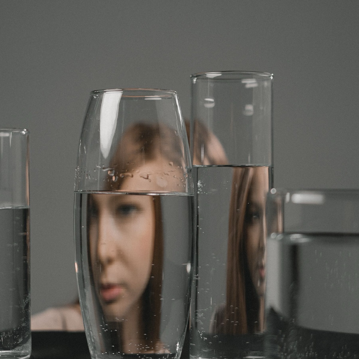 Woman inspecting a glass of water